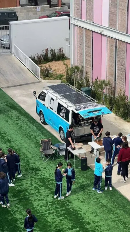 The Jacob's Brew coffee van parked in a school yard, serving hot drinks to a queue of pupils